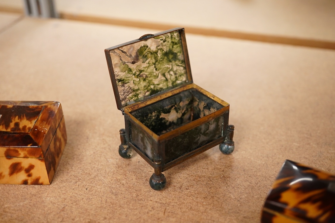A 19th century miniature brass and agate trinket box and two early 19th century tortoiseshell needle boxes, largest 5.5cm wide x 2.5cm high